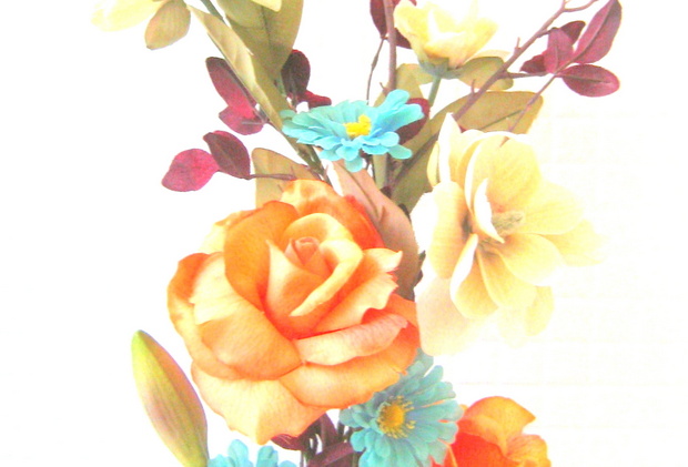 Faux flowers in shades of blue, orange, cream and eggplant