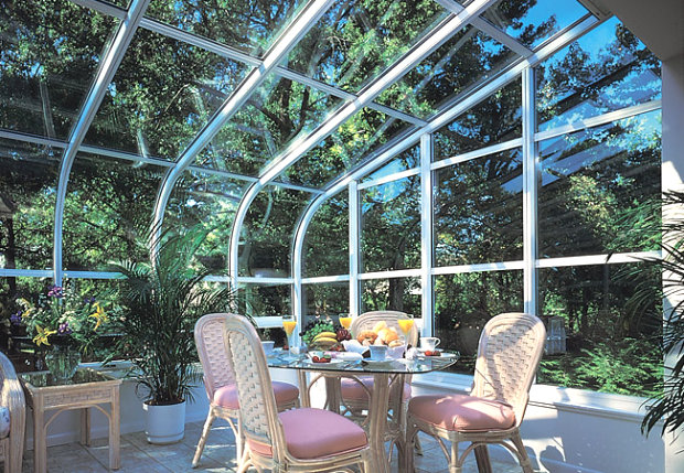 Curved sunroom with a potted palm